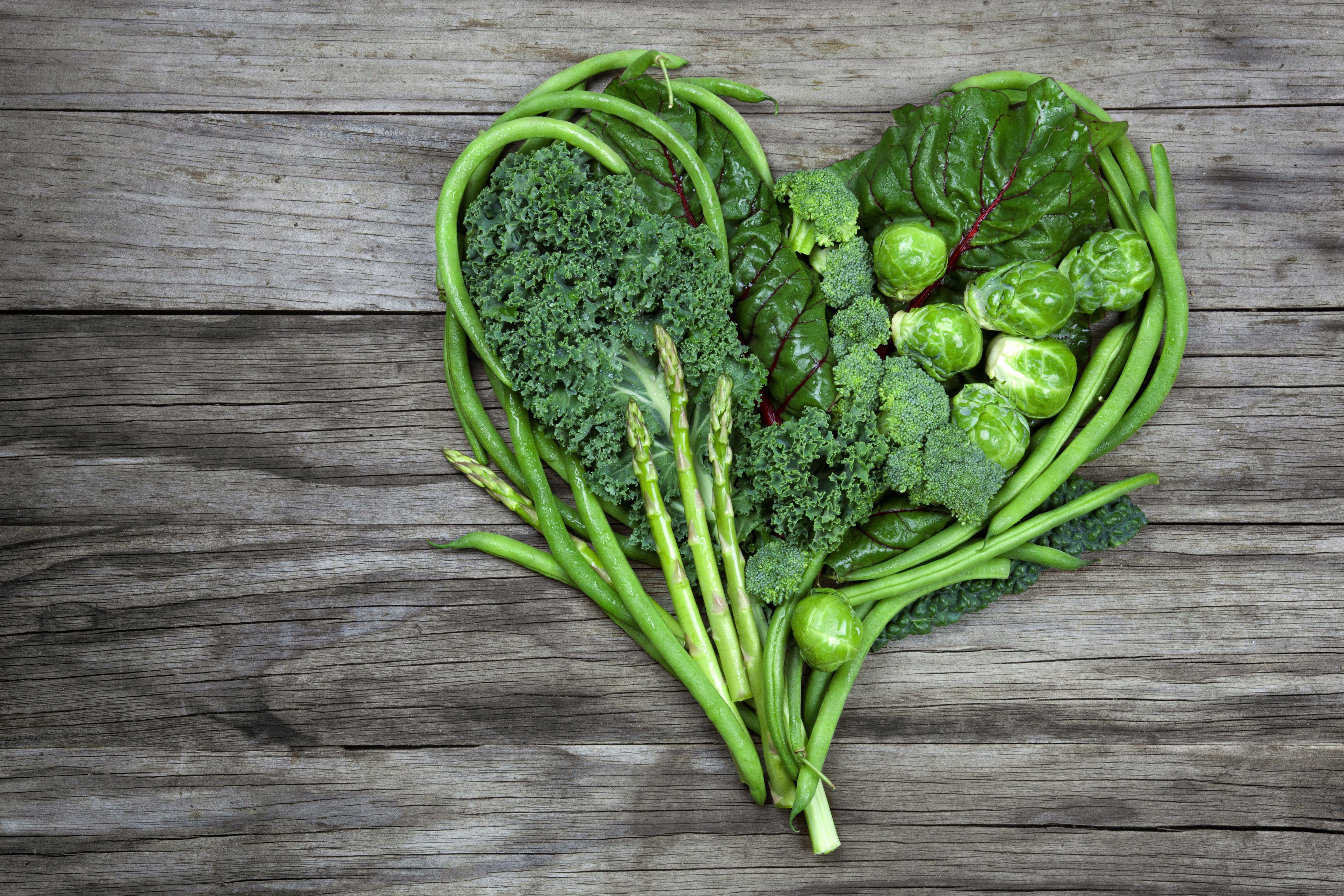 Broccoli, green beans, sprouts and asparagus in the shape of a heart