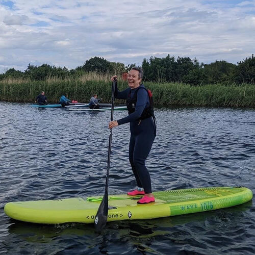 Slimming World member paddleboarding
