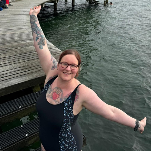 Slimming World member Tabitha standing on the edge of a lake